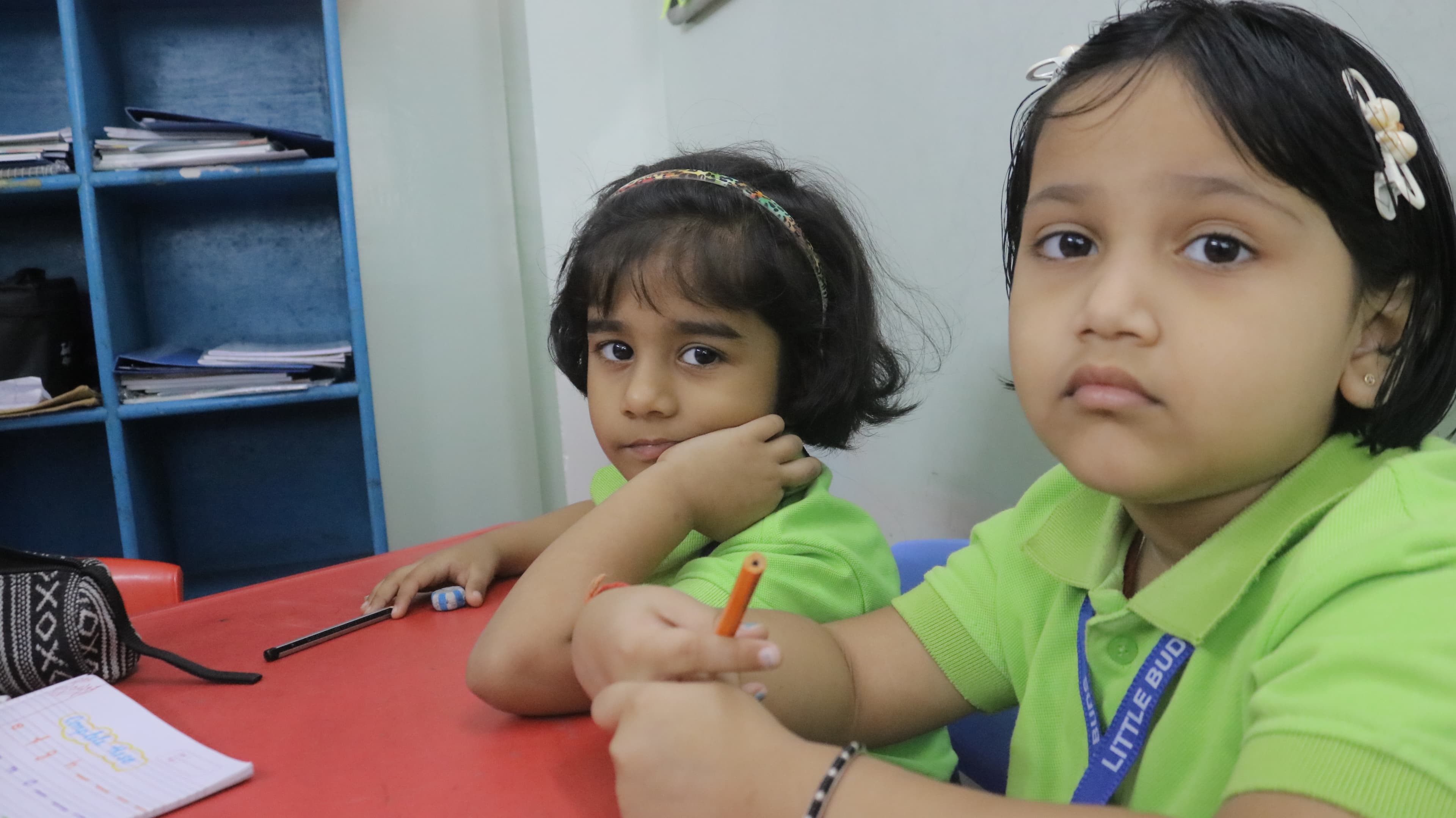 Two Little Buds students working together at their desks