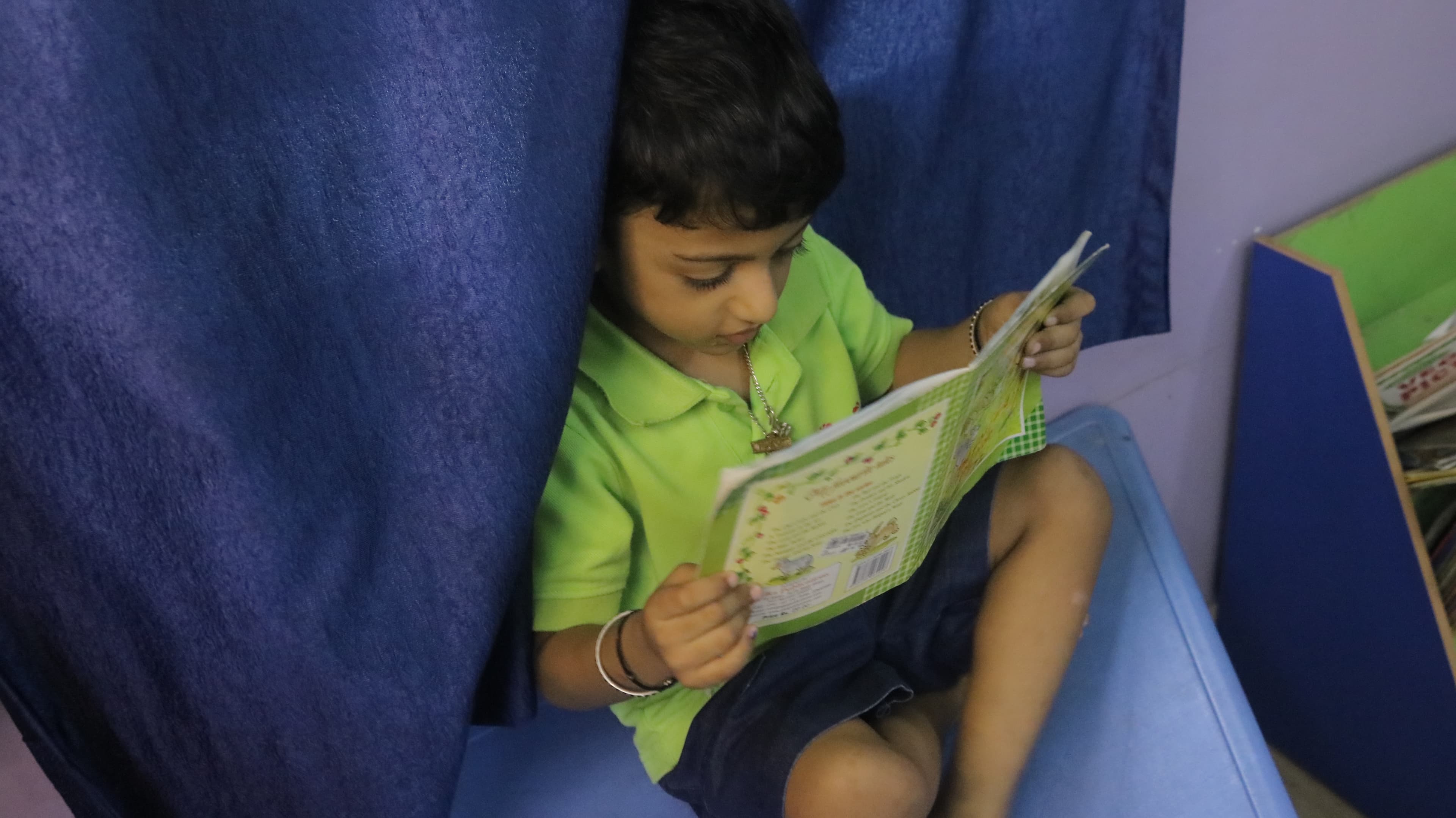 Little Buds student reading a picture book