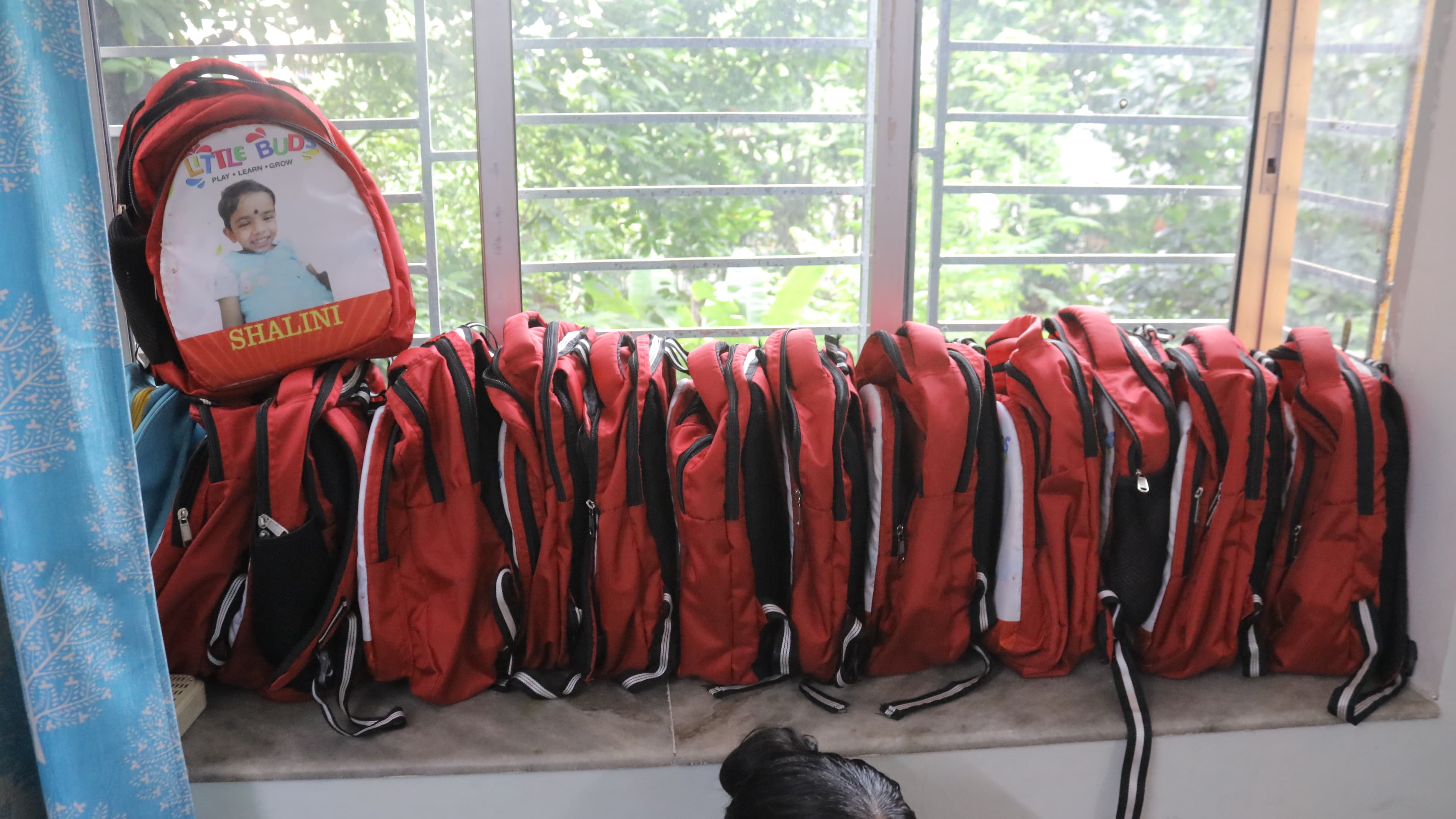 Little Buds school bags displayed by the window