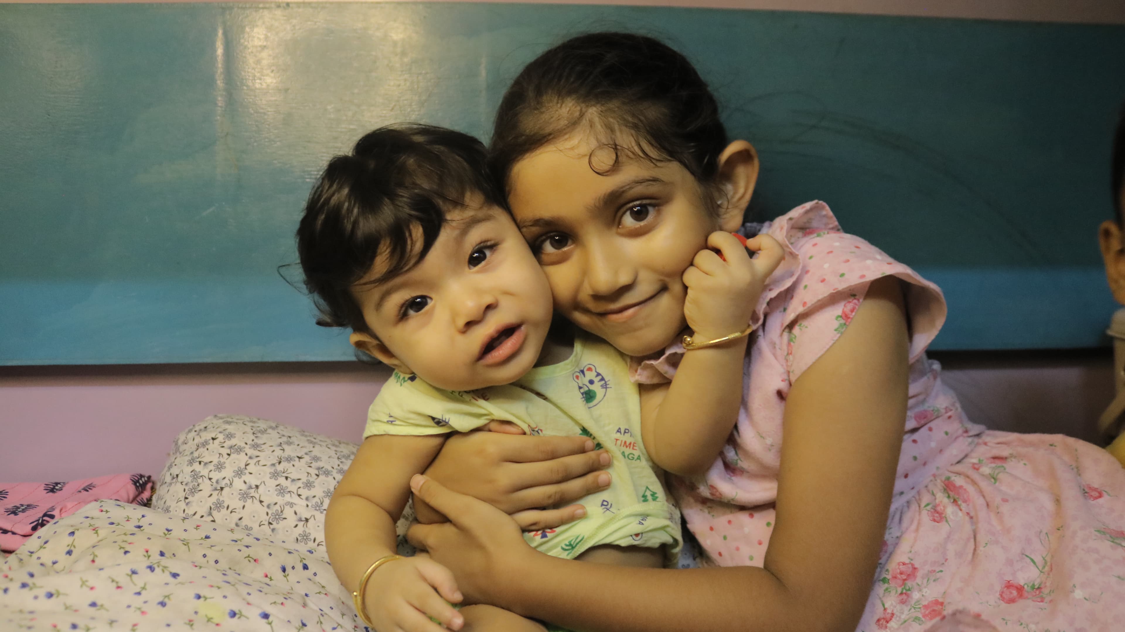 Young children sharing a tender moment at Little Buds creche