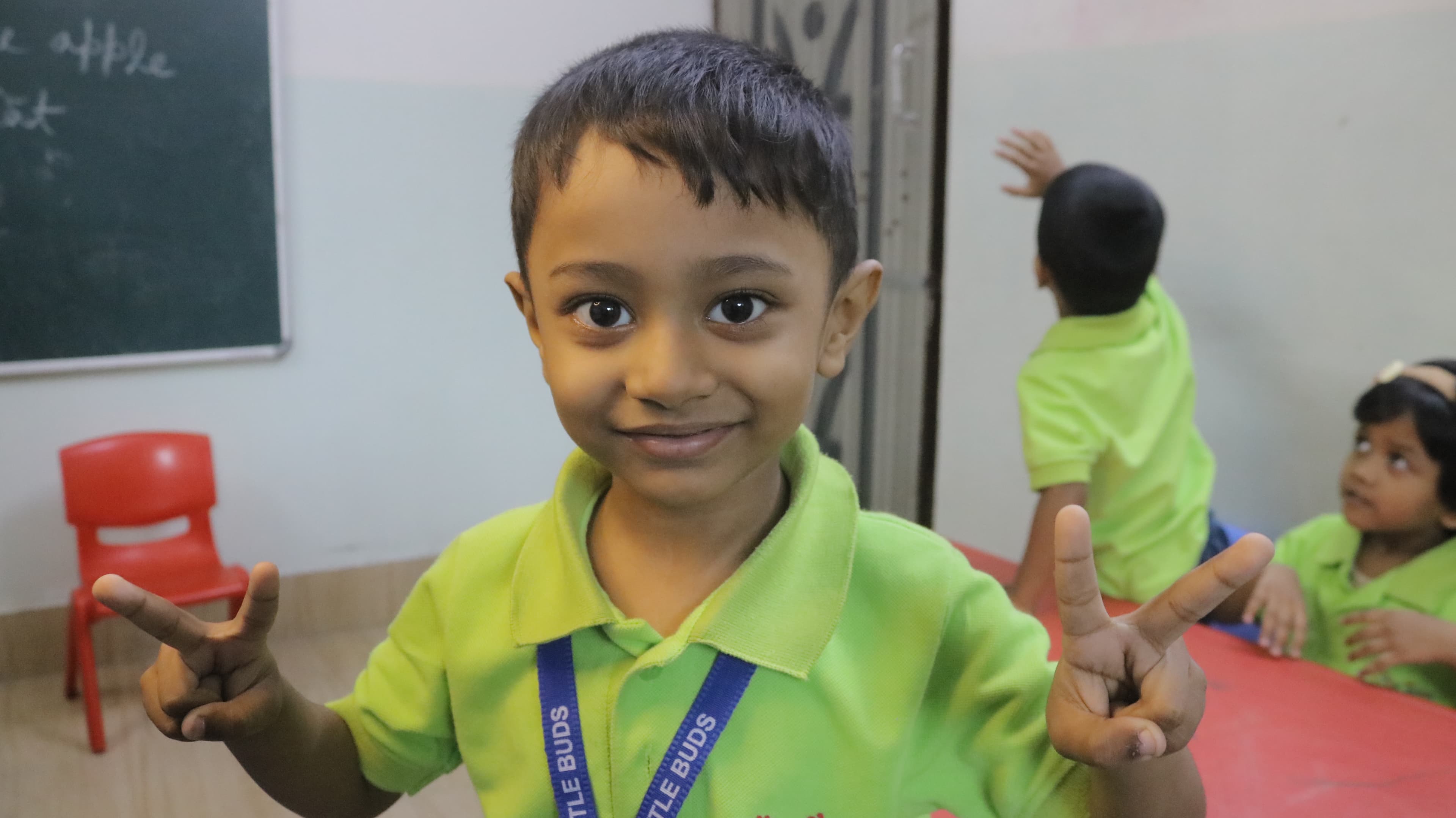 Little Buds student smiling happily