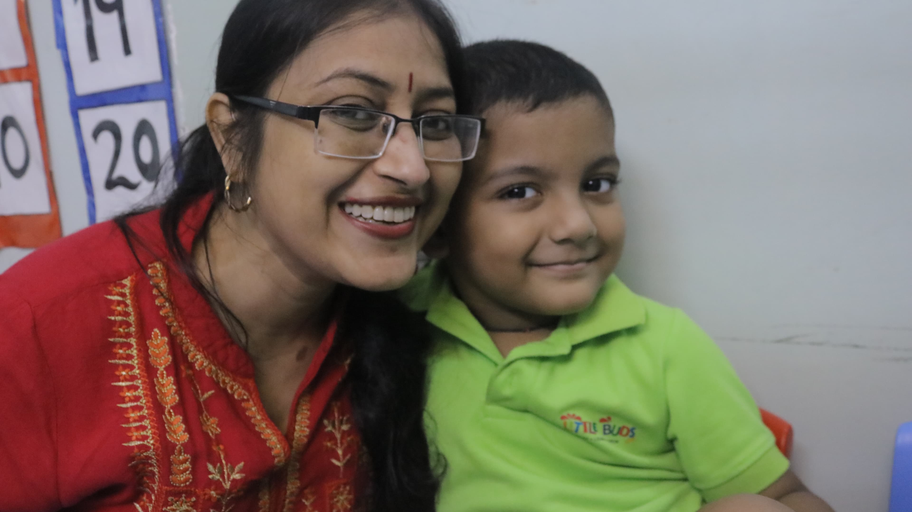 Teacher and student smiling together at Little Buds